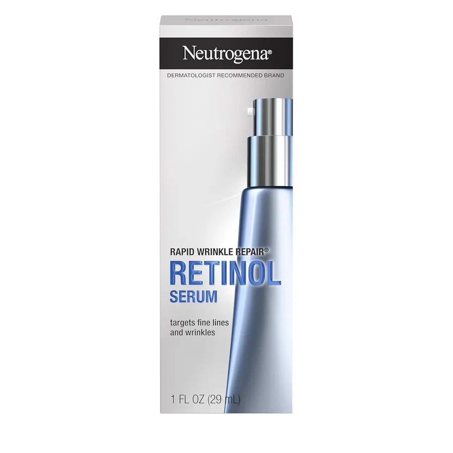 Hand holding a small bottle of Neutrogena Rapid Wrinkle Repair retinol serum against a white bathroom shelf