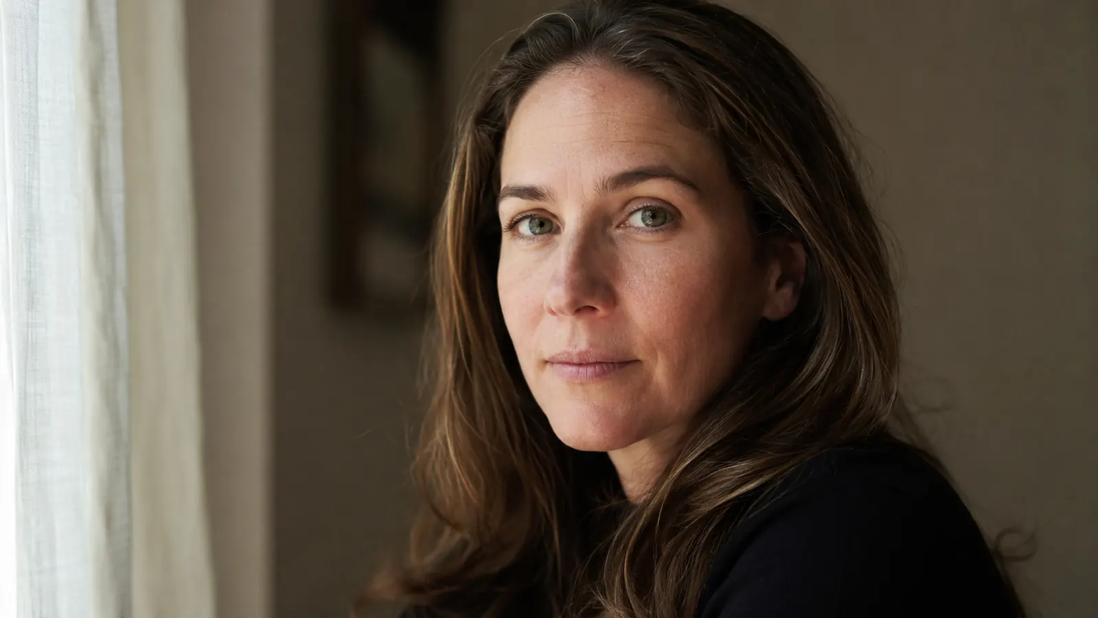 Woman looking refreshed with noticeably less under-eye puffiness in natural light